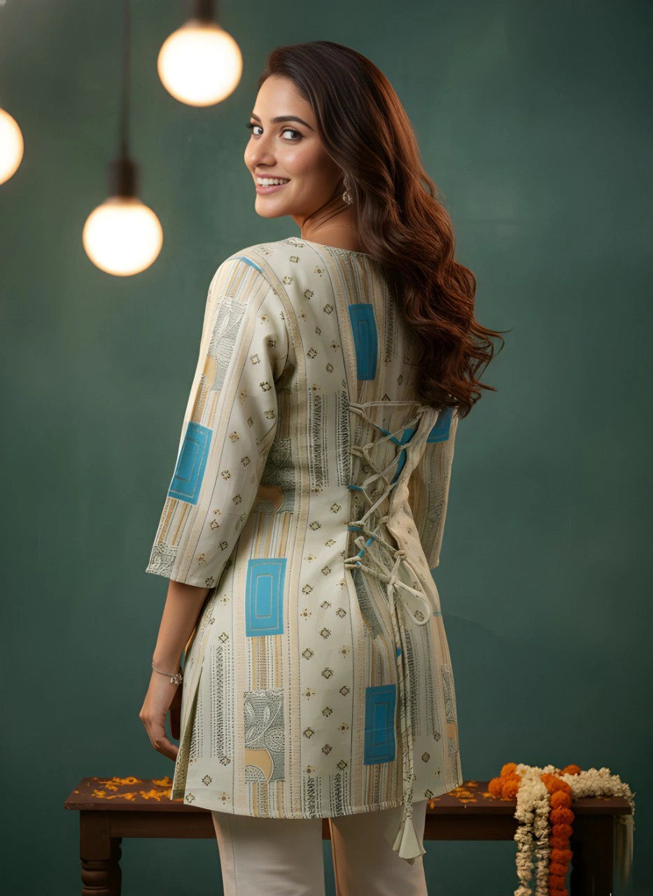 Woman wearing a patterned kurta with blue accents against a green background